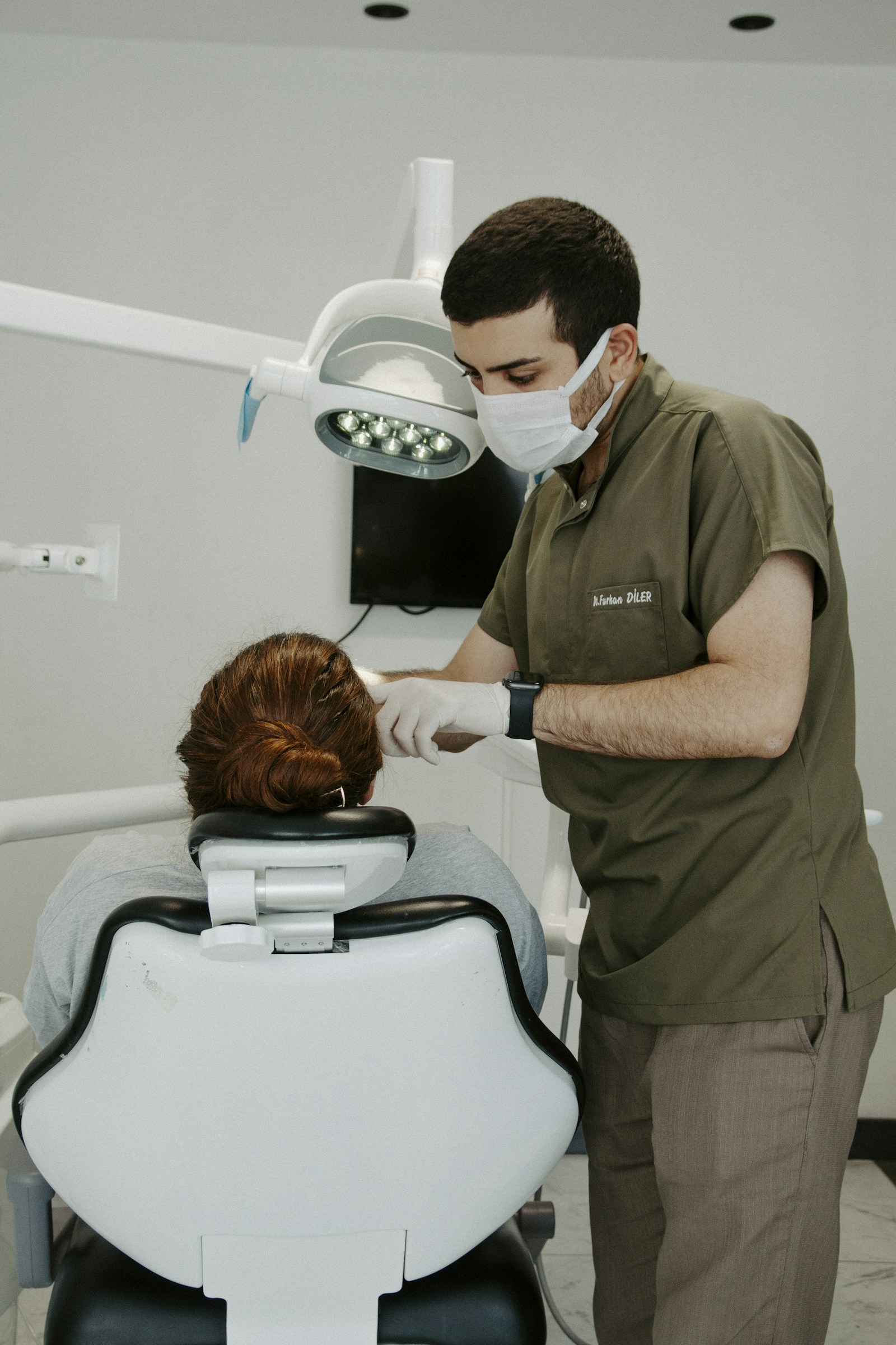 Illustrative stock photo of a dental professional caring for a patient; not Dr. Chan